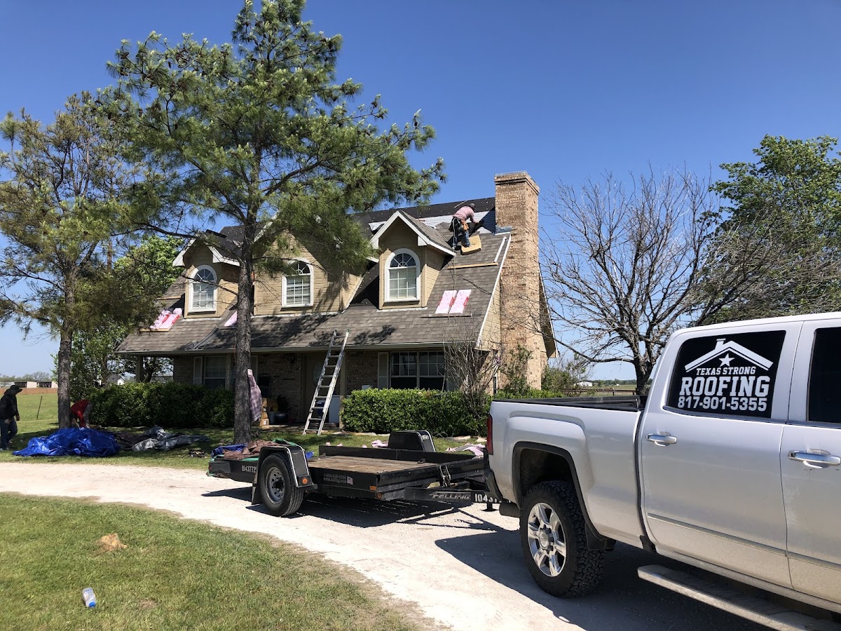 Rafter T crew actively re-roofing a large home